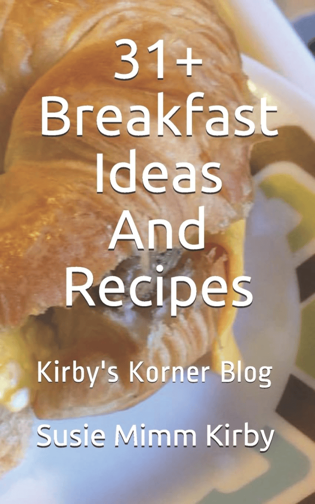 A close-up of a croissant on a plate, with text overlay reading '31+ Breakfast Ideas And Recipes' and author's name 'Susie Mimm Kirby'.
